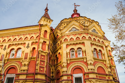 his striking building in Irkutsk features intricate architecture, rich colors, and charming details during autumn. Irkutsk city, historical building.	