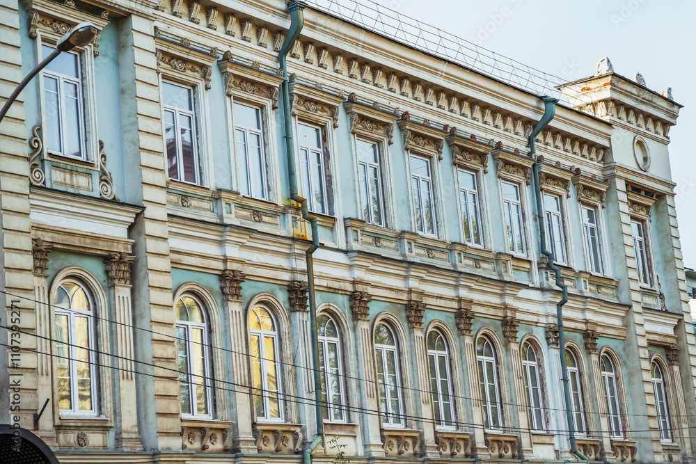 Fototapeta premium A beautifully detailed building in Irkutsk displays classic architecture with ornate moldings and large windows.