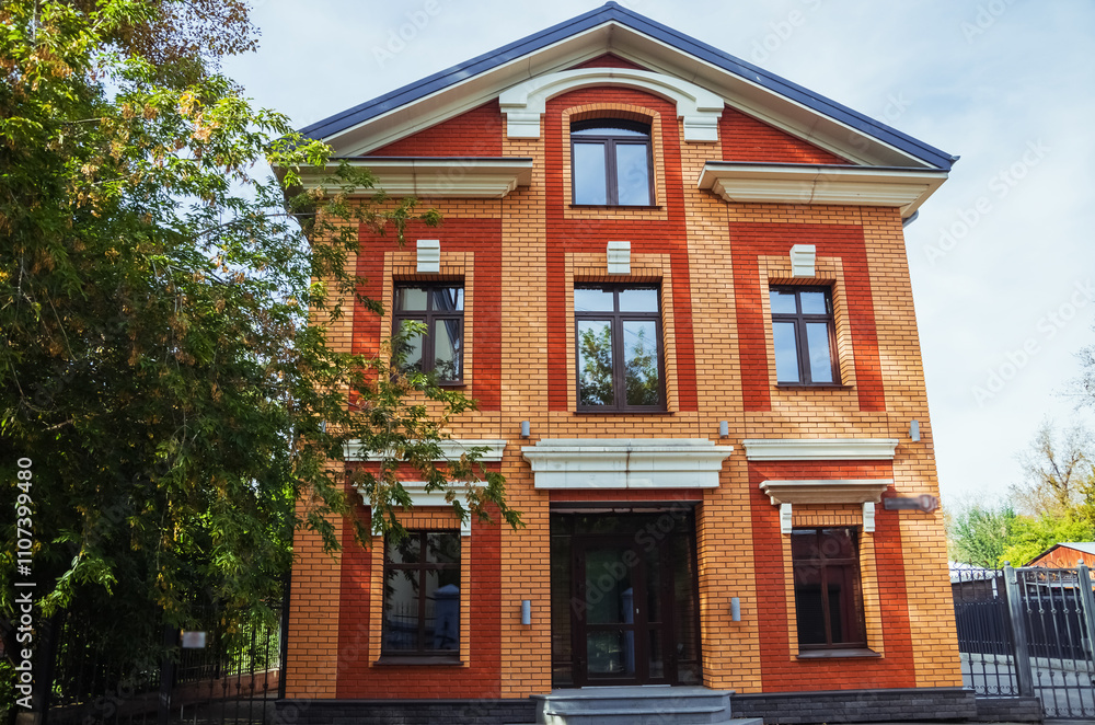 Beautiful brick facade of a building in Irkutsk, showcasing architectural style amidst autumn colors. Beautiful brick facade of a building in Irkutsk, showcasing architectural style amidst autumn colors.