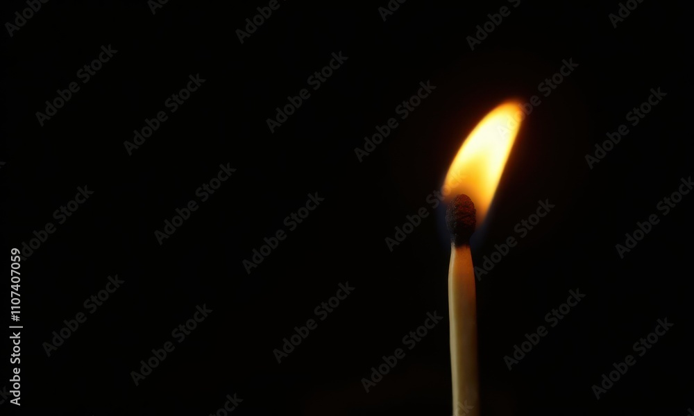 Match is burning on black background Match is burning on black background