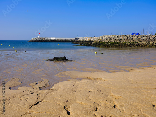 Sea and beach at low tide and lighthouse of La Turballe, a commune in the Loire-Atlantique department in western France. 