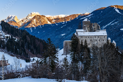 The castle Burg Heinfels in the austrian Alps at the austrian italian border in Sillian in winter sunset. photo