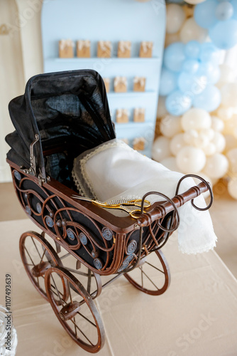 A vintage-inspired baby shower setup with a miniature stroller and delicate decorations