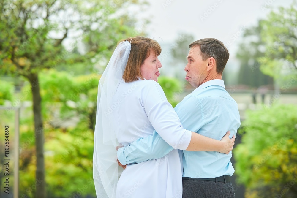 Obraz premium An adult bride and groom . Husband and wife's wedding anniversary photo shoot. We've been together for 30 years.
