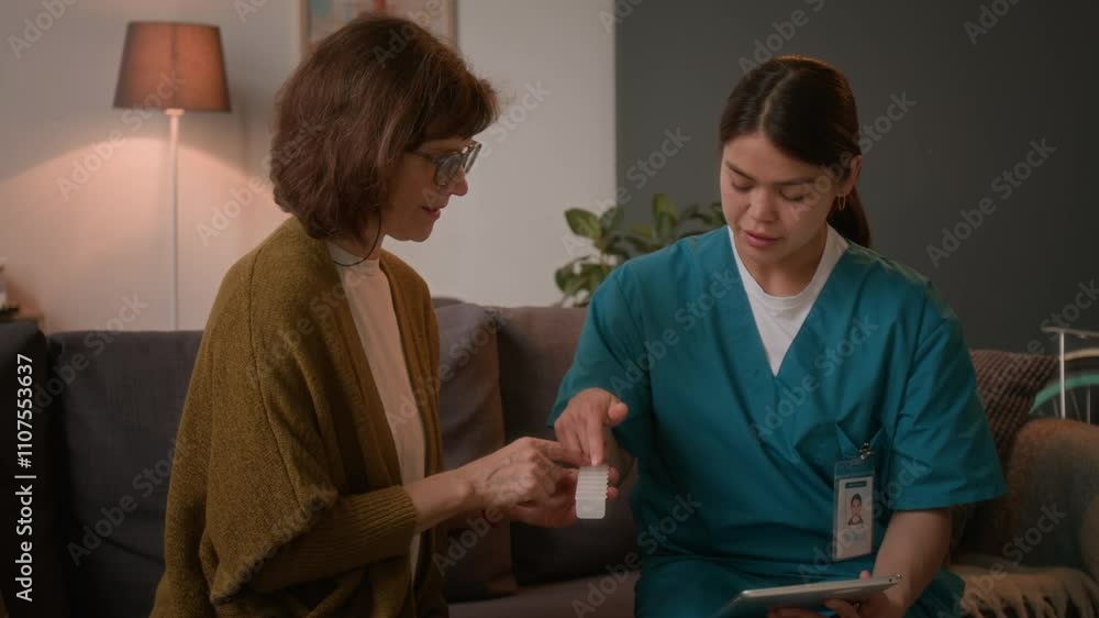 custom made wallpaper toronto digitalFemale nurse in medical scrubs talking with senior woman about her pills while sitting on couch in living room during home care visit