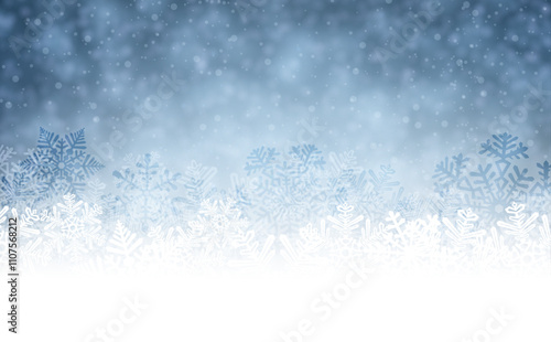 Vector illustration of a frosty winter background featuring white and blue snowflakes with a soft gradient effect.