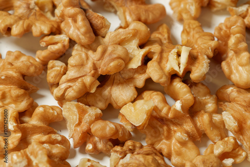 shelled walnuts lying on white background