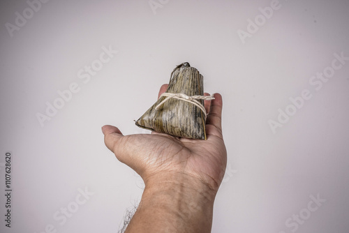 Bacang, also called bakcang or zongzi, is a traditional Chinese confectionery made from rice with various fillings. One that can be made by yourself meat stuffed bacang. photo