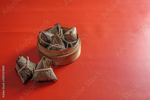 Bacang, also called bakcang or zongzi, is a traditional Chinese confectionery made from rice with various fillings. One that can be made by yourself meat stuffed bacang. photo