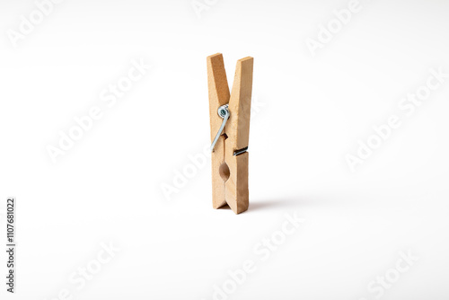 Wooden clothes peg isolated on white background
