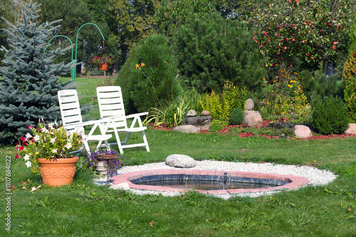 white plastic chairs for relaxing in the garden
