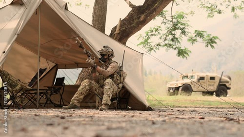 Soldiers in camouflage uniforms planning on operation in the camp