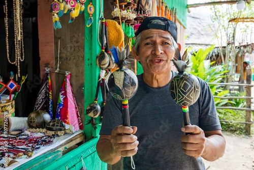 Peruvian jungle artisan working on his products to sell them in his market stall. photo