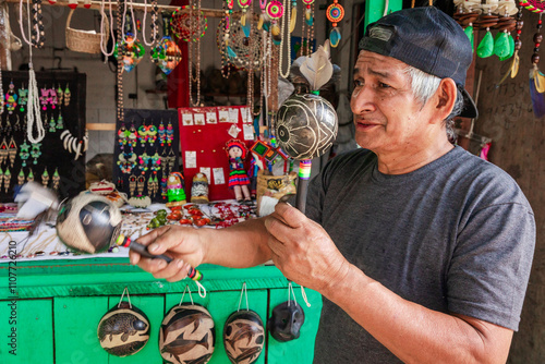 Peruvian jungle artisan working on his products to sell them in his market stall. photo