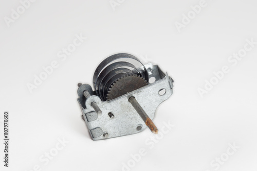 clock spring, metal gear in housing with handle to tightening  power spring. part of mechanism