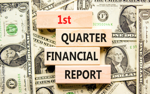 1st quarter financial report symbol. Concept words 1st quarter financial report on beautiful wooden blocks. Beautiful dollar background. Business 1st quarter financial report concept. Copy space. photo