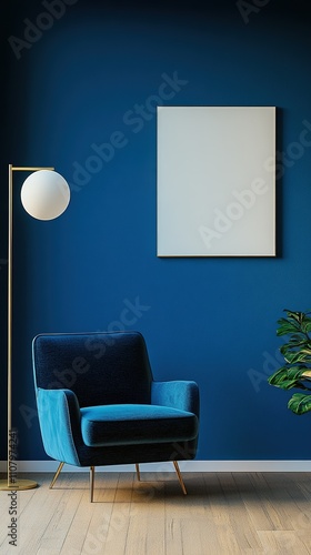 Modern interior with a stylish blue armchair, a gold floor lamp with a round white shade, a blank canvas on a deep blue wall, and a green plant on wooden flooring