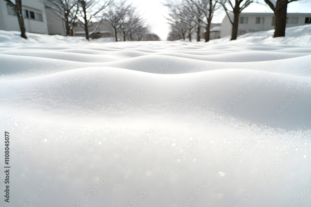 Fototapeta premium Close-up of snow with ripples and shadows on its surface, capturing the intricate textures and patterns formed by wind and light, creating a serene and detailed winter landscape