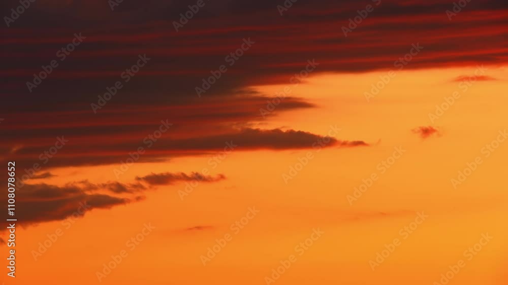 Sunset in the orange yellow red sky timelapse. Epic bloody bright clouds in the evening. Vibrant color background time Lapse. Cinematic rainy summer sky. Sunset in the orange yellow red sky timelapse. Epic bloody bright clouds in the evening. Vibrant color background time Lapse. Cinematic rainy summer sky.