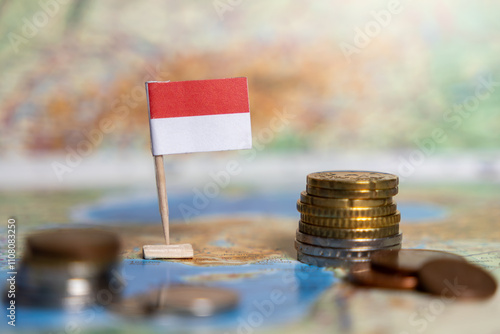 indonesia flag on map with stacked coins, economic growth, trade, investments, currency exchange, wealth, financial system, global market, commerce, banking, monetary policy, fiscal stability photo