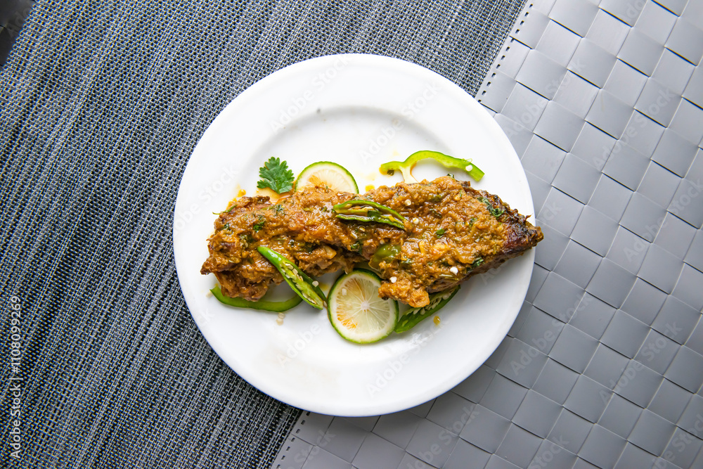 Rohu fry fish topping with lemon slice, green chili and coriander ...