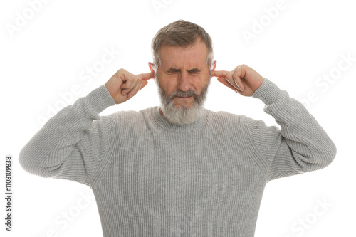 Senior man covering his ears with fingers on white background photo