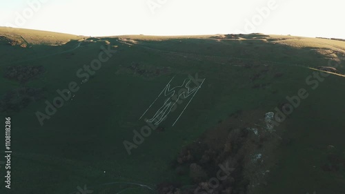 Aerial drone footage of the Long Man of Wilmington. Believed to date back to the Iron Age, this enigmatic landmark remains a captivating symbol of Britain's prehistoric heritage. photo