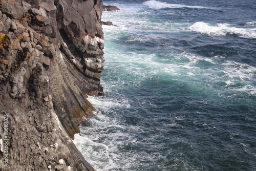 Majestic Waves Crashing Against Rocky Shoreline in Iceland