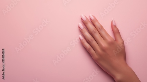 Woman hand showing cream nails on pink background