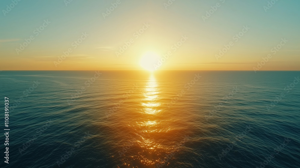 Obraz premium Sunset over calm ocean waters with golden reflections and vibrant sky colors