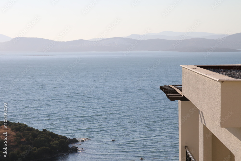 Minimalist seascape with a balcony overlooking the ocean, perfect for a postcard or travel brochure