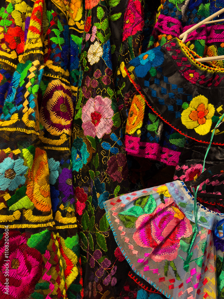 Fototapeta premium Detailed view of floral and colorful embroidery on traditional Mexican dress