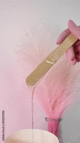 Master of depilation prepare paste for sugaring. Close-up, vertical, pink, no face