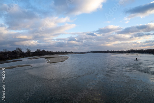 Wild unregulated Vistula River in Poland in Europe, island and clouds with blue sky