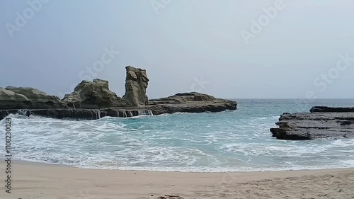 Close up of huge waves washing over the coastline and rocks.
