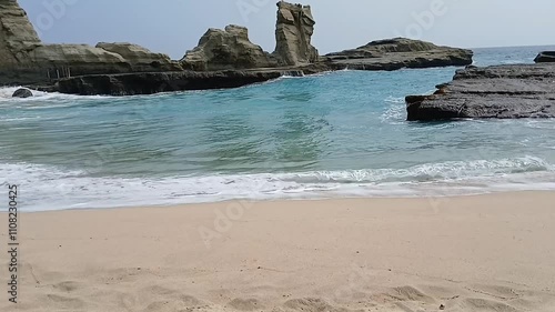 Close up of huge waves washing over the coastline and rocks.