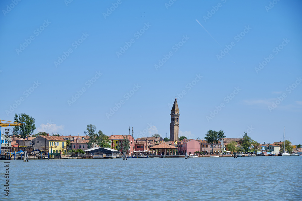 Fototapeta premium Burano, Venice: Colorful houses of Burano island. Multicolored buildings on fondamenta embankment of narrow water canal with fishing boats and stone bridge, Venice Province, Veneto Region, Italy.