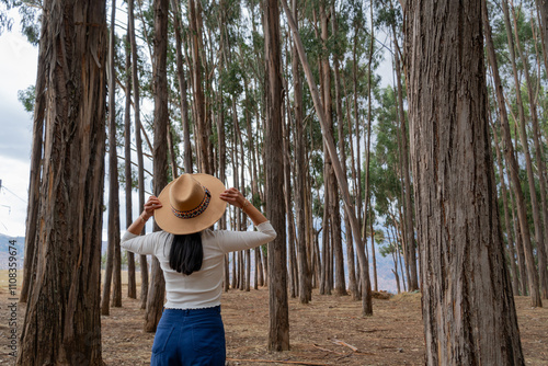 young female tourist enjoying the eucalyptus forest in qenqo cusco photo