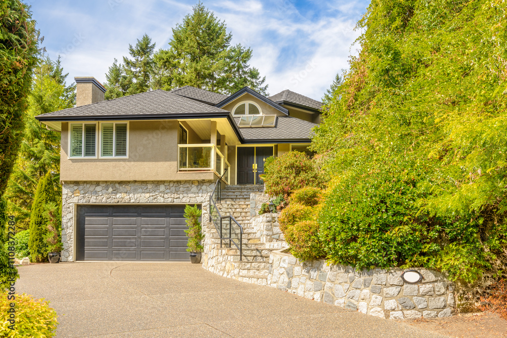 Garage door in luxury house with trees and nice landscape in Summer in Vancouver, Canada, North America. Day time on June 2024. Garage door in luxury house with trees and nice landscape in Summer in Vancouver, Canada, North America. Day time on June 2024.