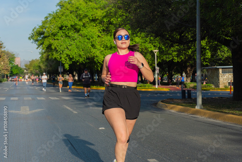 Young woman running on a city street during a sunny day