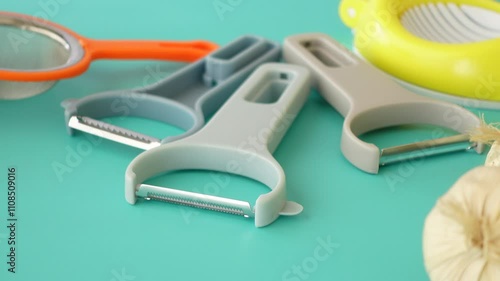 A vibrant collection of kitchen tools, including a vegetable peeler photo