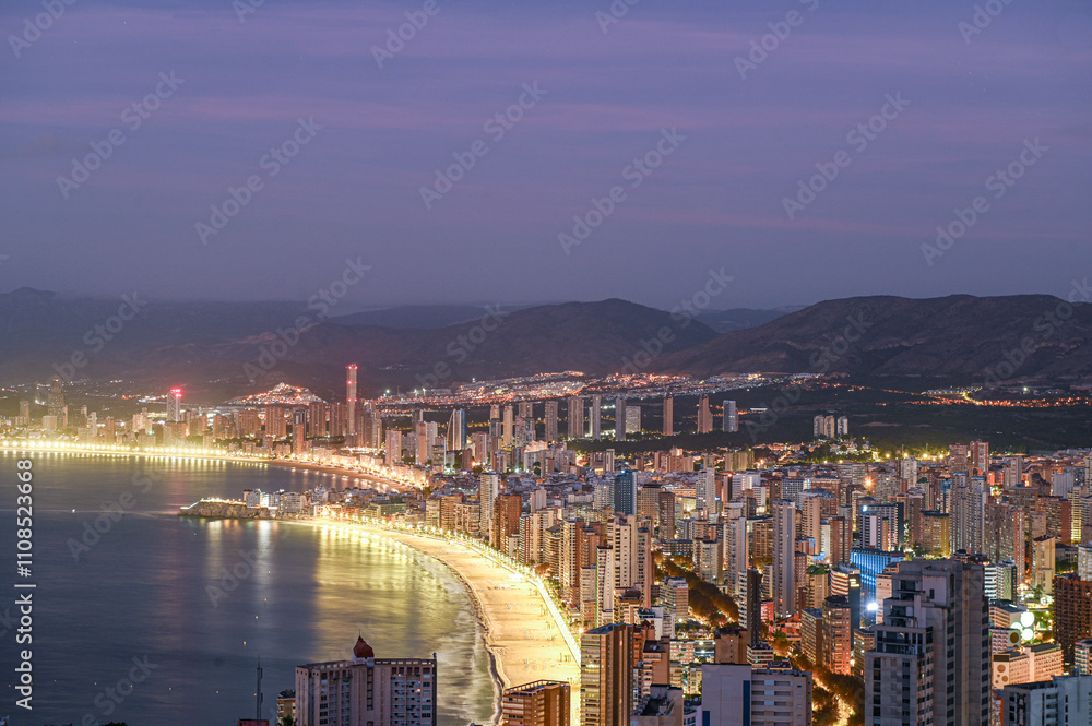 Sunrise on a clear day over Benidorm in Spain from the Mirador de la Cruz