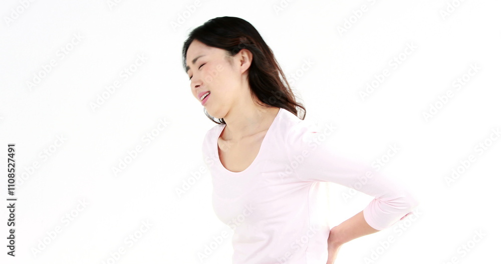 Pretty Asian woman with stomach ache on white screen Pretty Asian woman with stomach ache on white screen