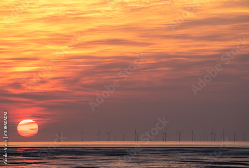 Sunset over sea at Burbo Bank wind farm photo