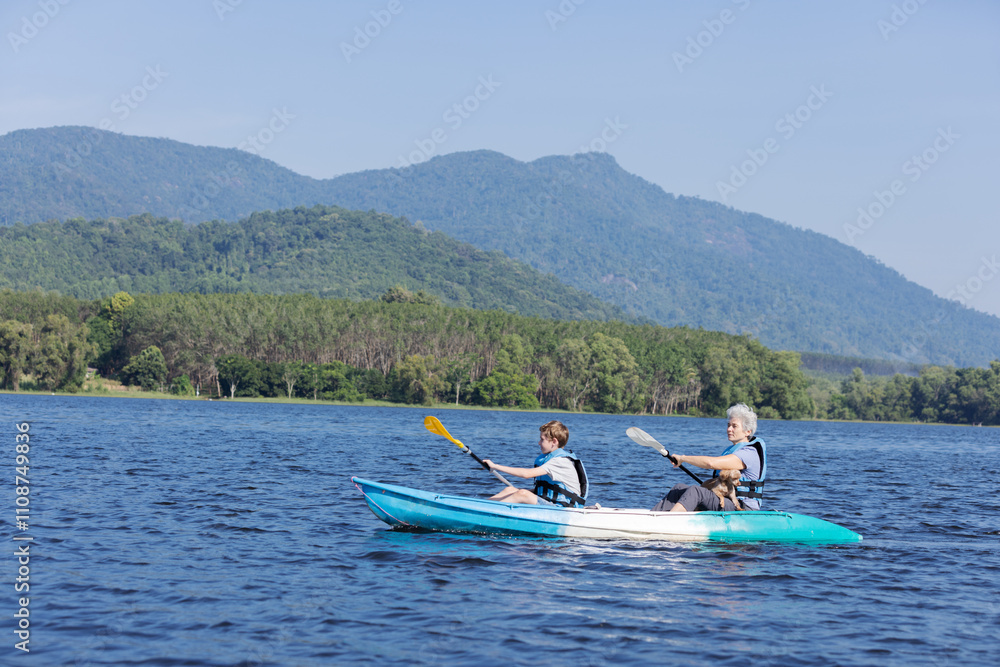 Fototapeta premium Grandmother and Grandson Kayaking with Their Dog on a Scenic Lake, Enjoying a Day Outdoors, Blue Waters, Sunny Day, Family Bonding, Adventure and Exploration in Nature, Peaceful and Relaxing Time