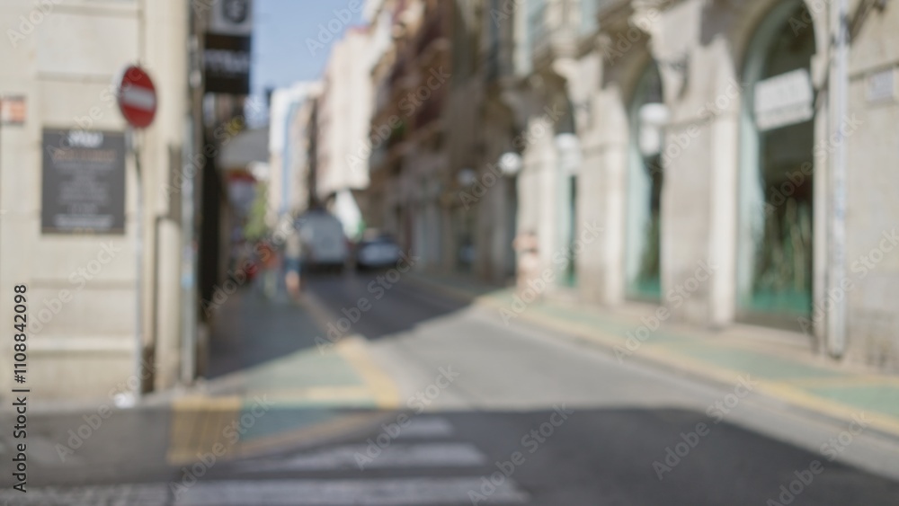 Obraz premium Defocused street scene in a european city with a blurred background featuring buildings and a car on a bright, sunny day with bokeh effect.