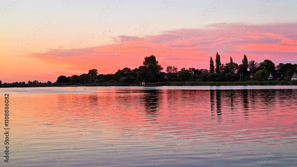 Naklejka premium View on Dutch water sports village during sunset, Oudega, Friesland, Netherlands
