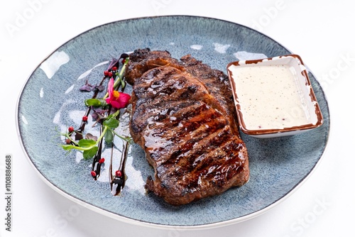 Huge Juicy Steak with Sauce on a Plate on a White Background photo