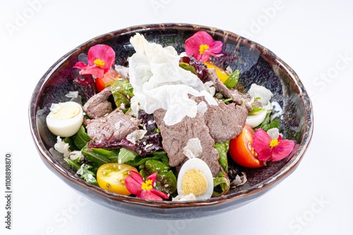 Hot Pan-Asian Salad with Meat, Egg, Greens, and Flower Garnish photo