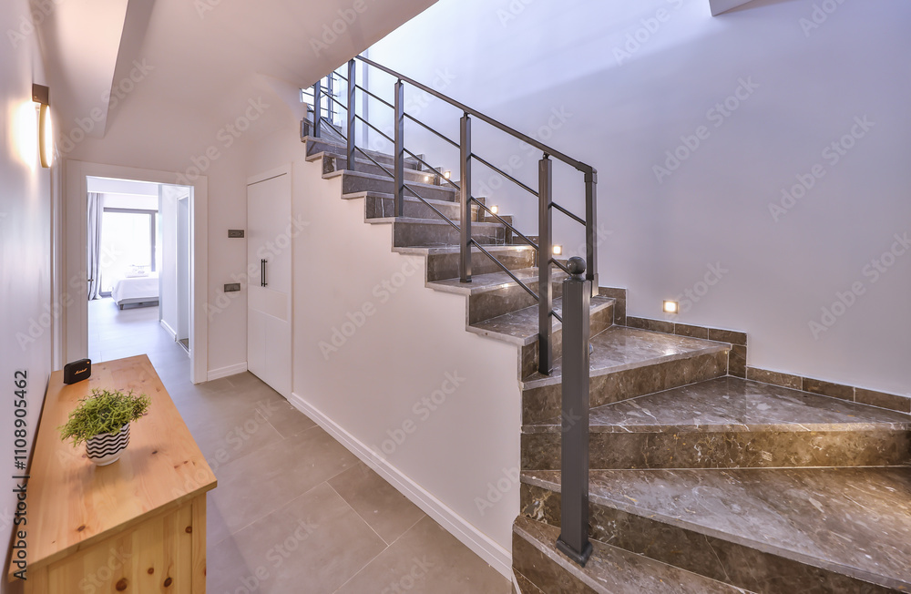 Contemporary interior design featuring a sleek staircase with subtle lighting